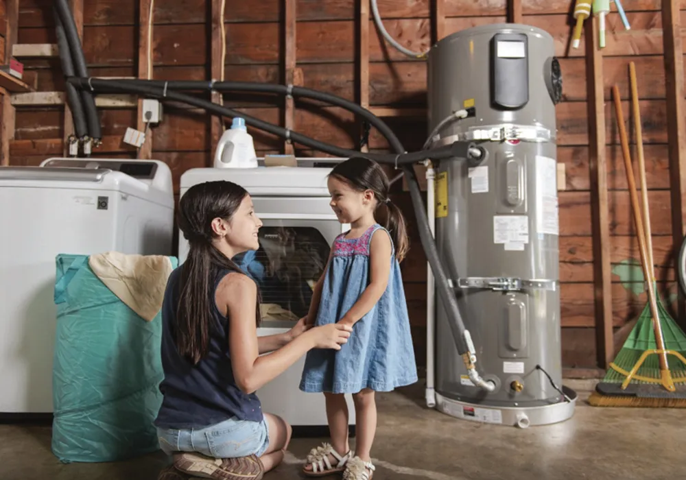 Two girls smiling in a laundry room.