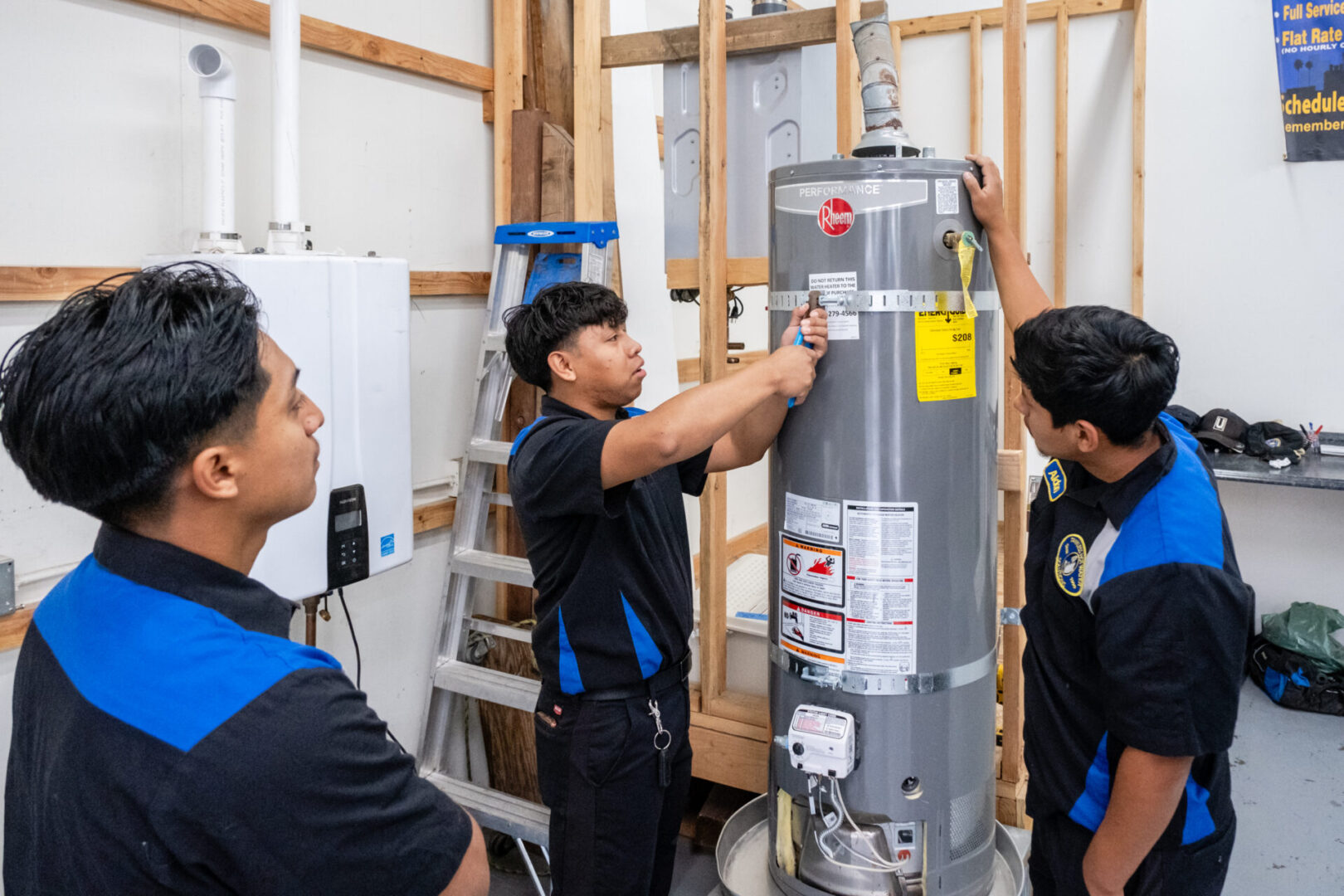 Two men working on a water heater.