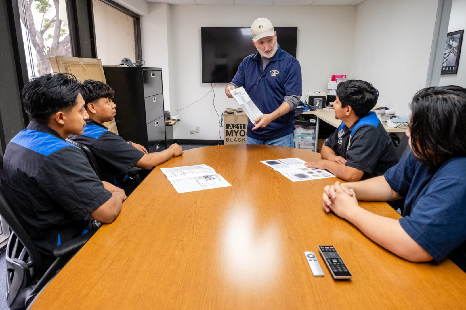 Four people in a meeting discussing a product.