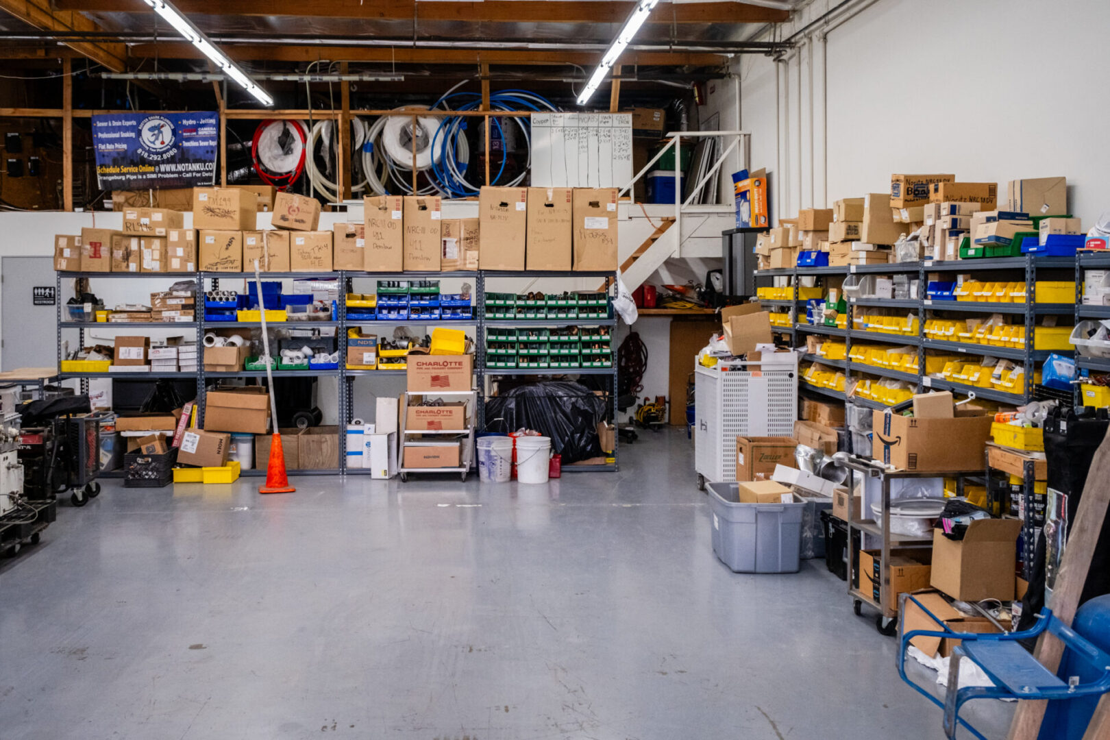 Warehouse with shelves of supplies and boxes.