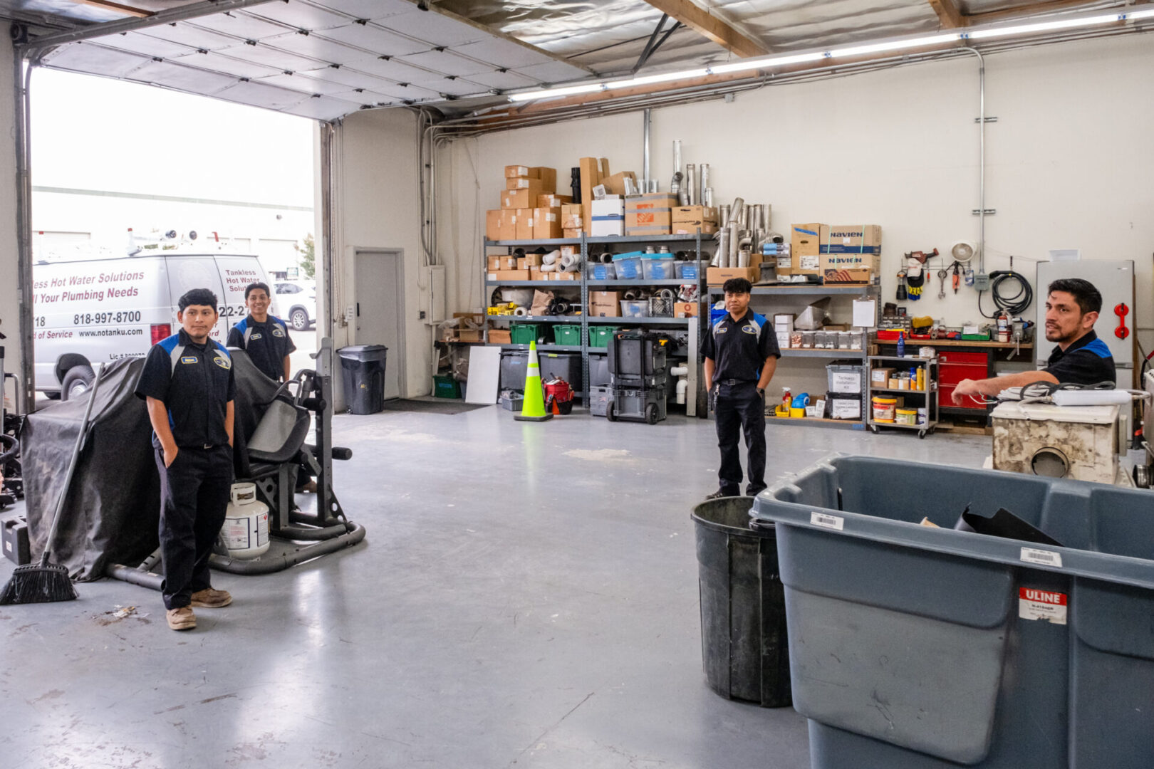 Four men working in a plumbing shop.